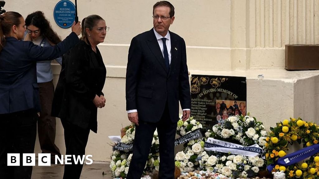 Israeli President Isaac Herzog lays a wreath for Bundy at the start of controversial visit